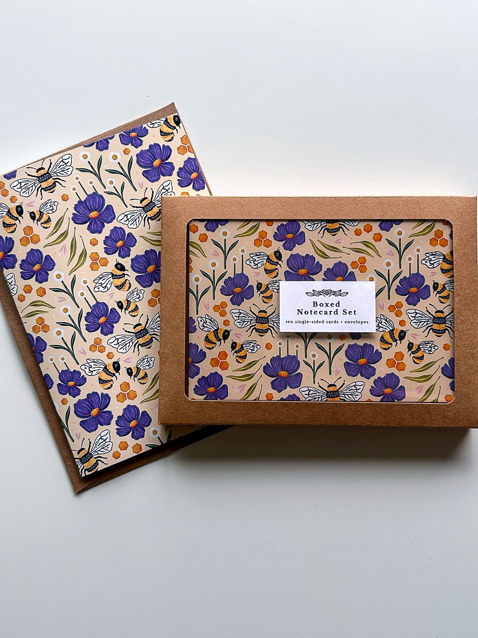 a box of cards and envelopes with a floral pattern on them .
