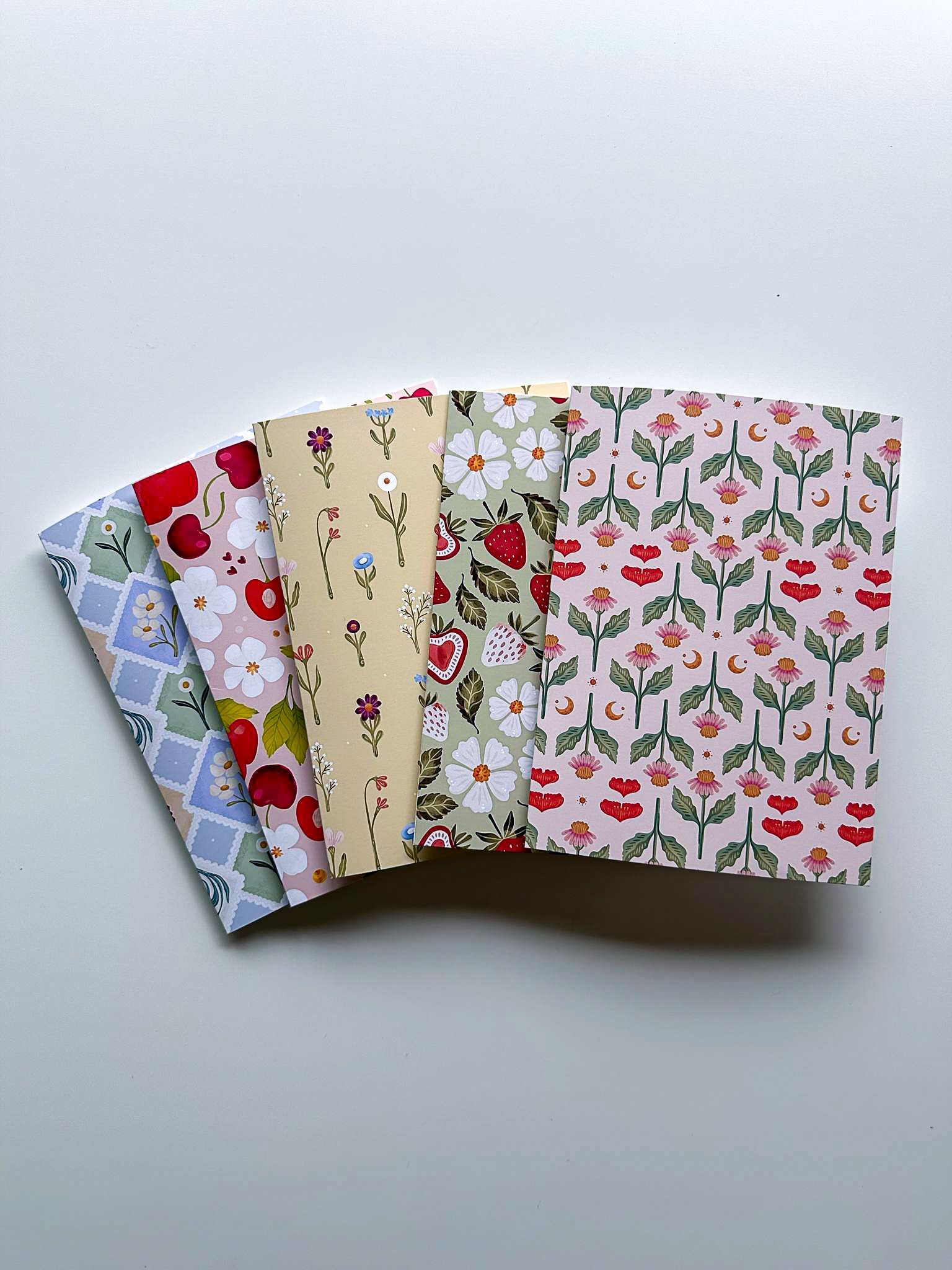 a greeting card with a painting of flowers and leaves on it .