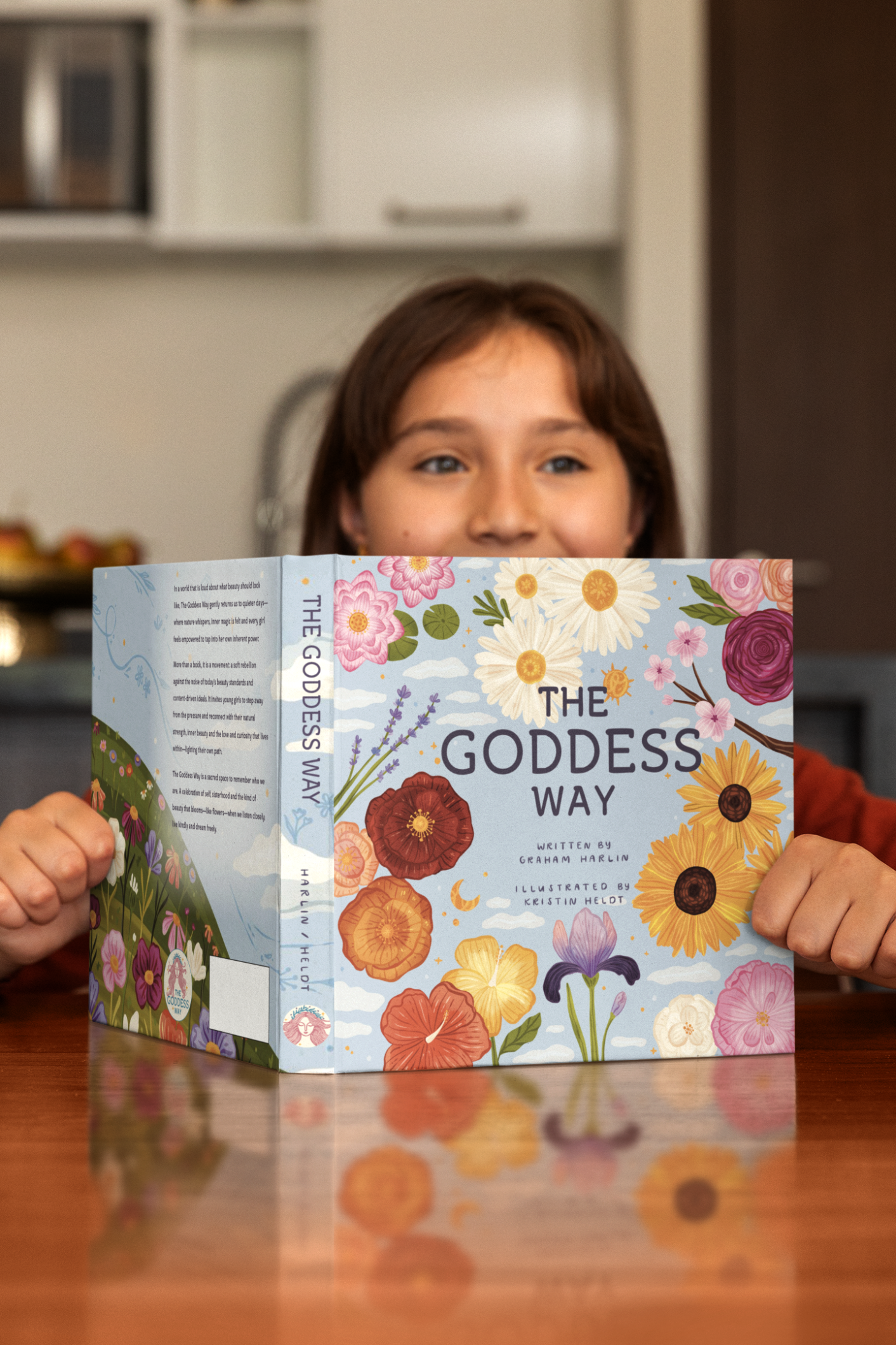 A person holding a light blue floral book titled 