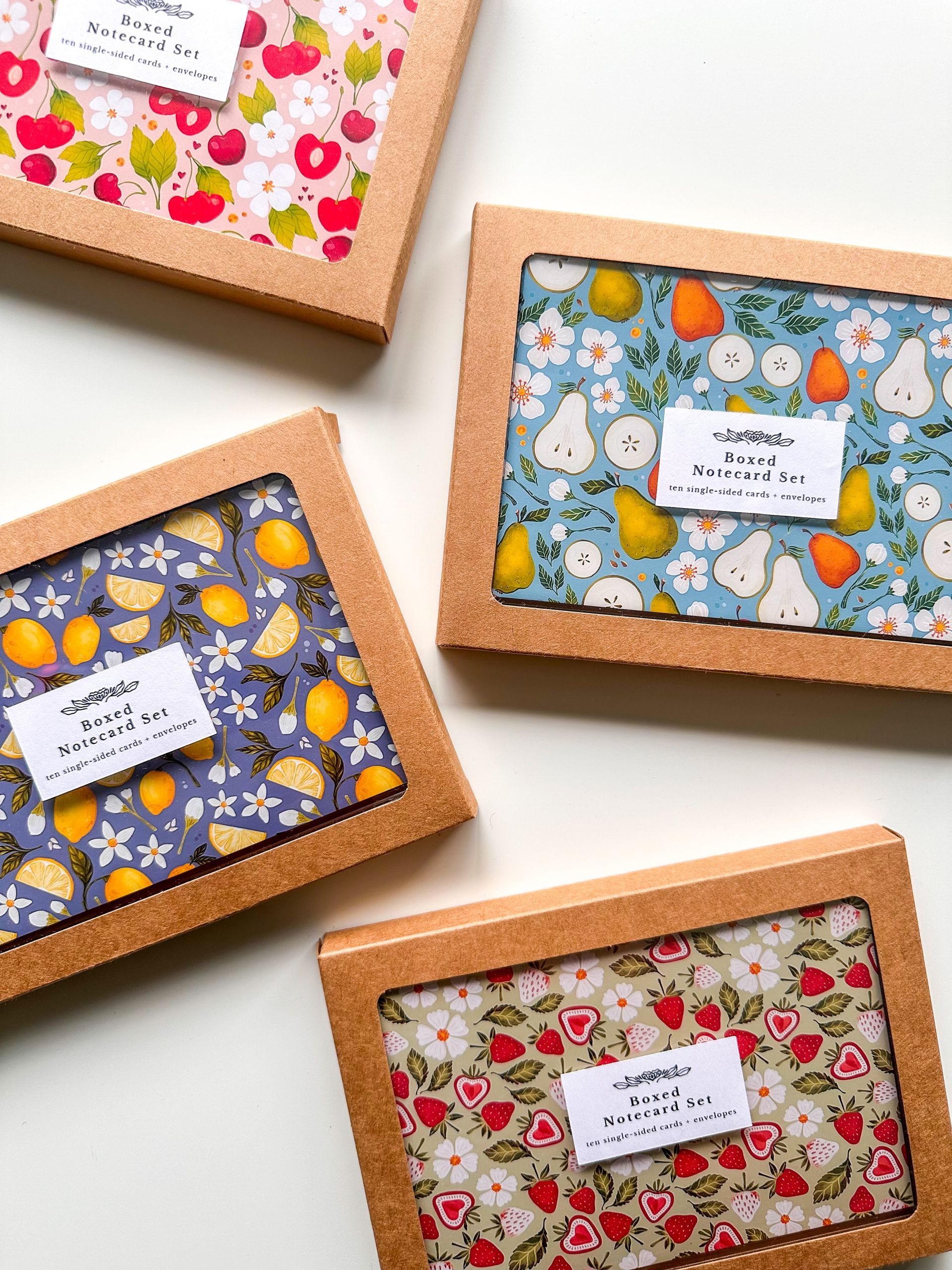 a box of cards and envelopes with a floral pattern on them .