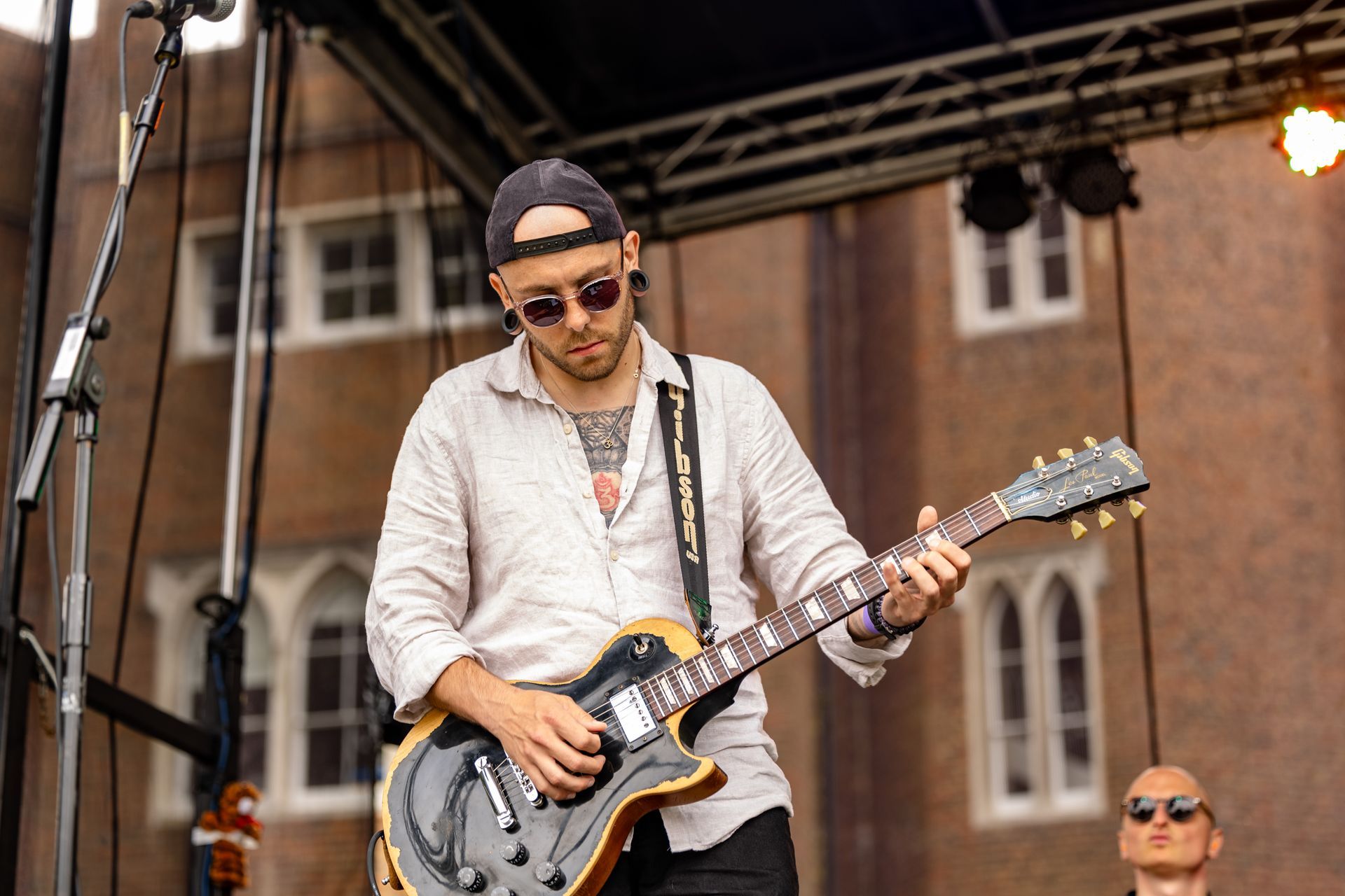 A solo performer on a trailer stage with a guitar