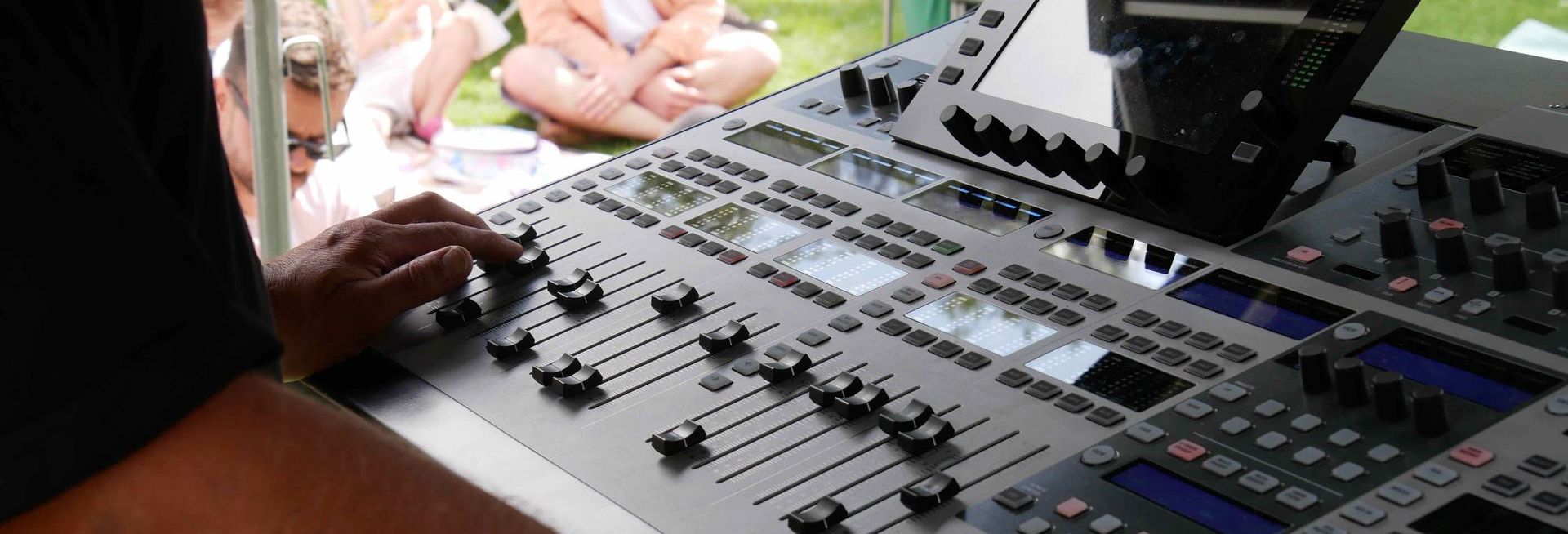 Close up of a sound desk with hands
