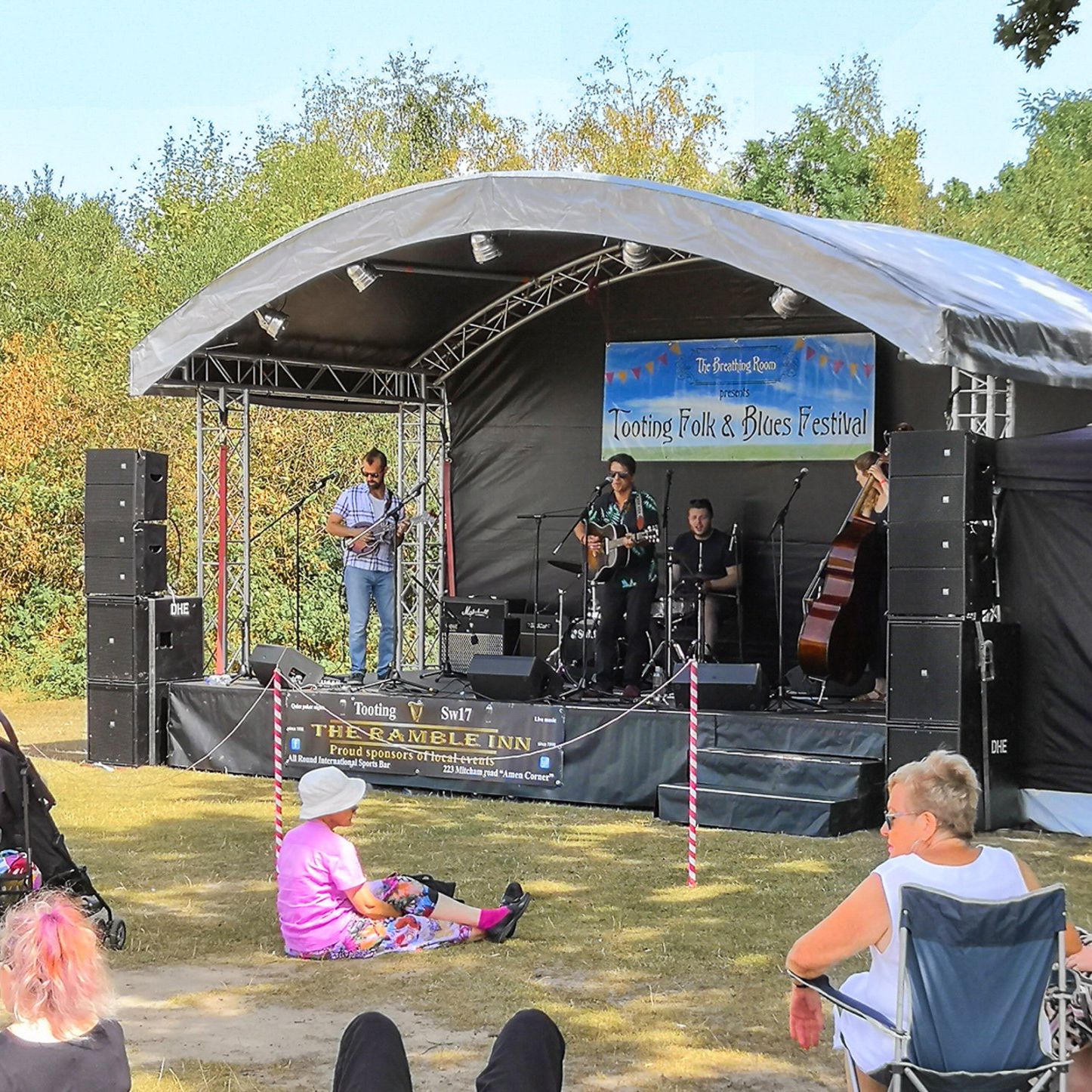 A small arc truss stage with a band performing