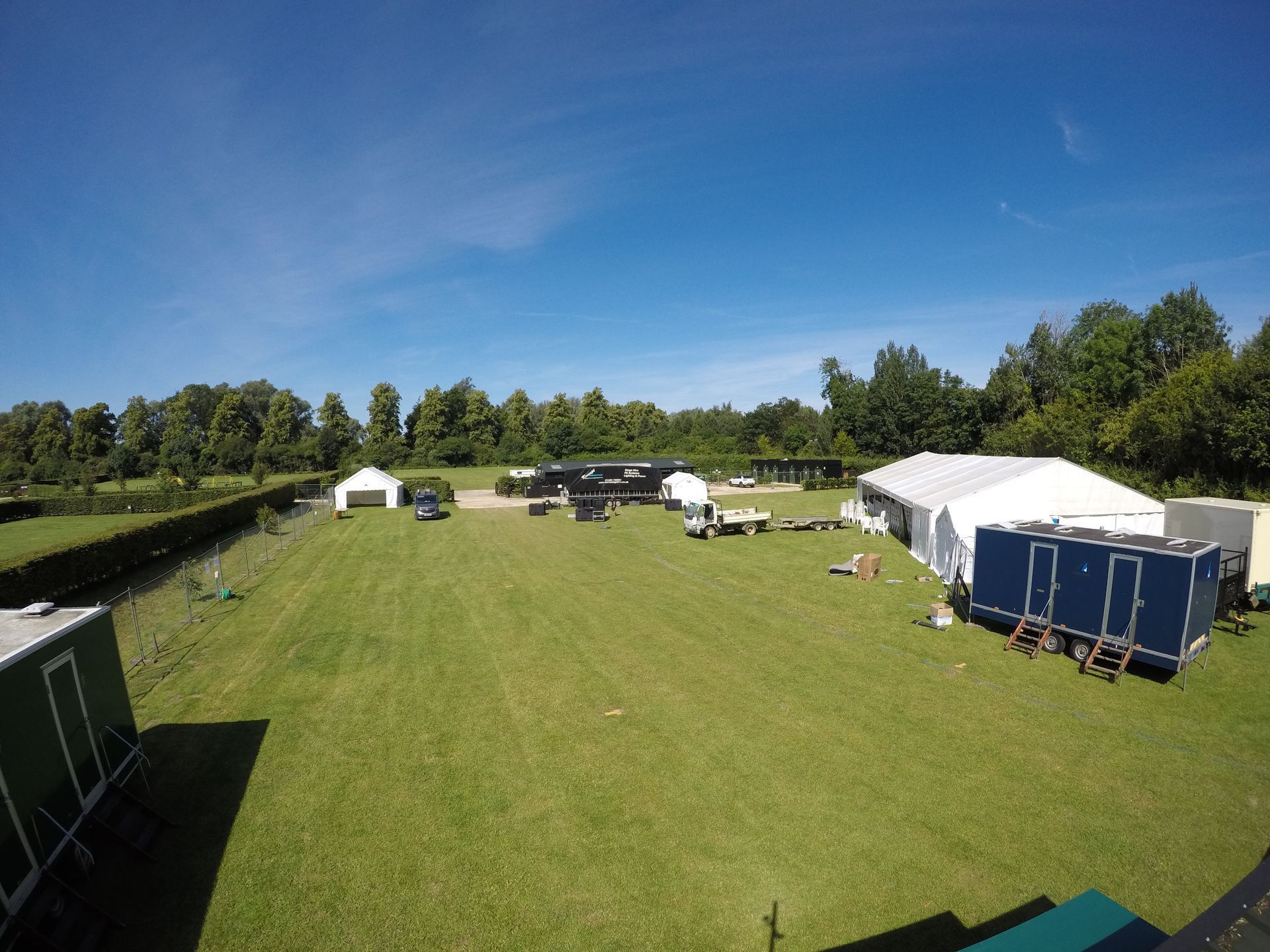 An empty event site with a green field with blue sky