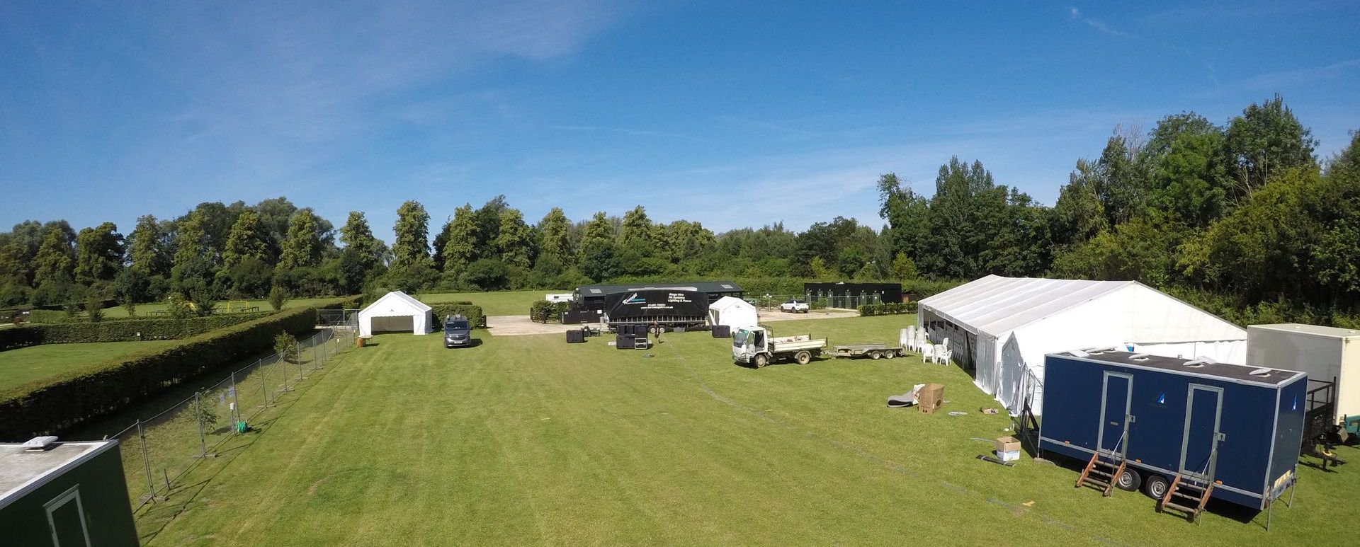 an event site on a green field with blue sky above