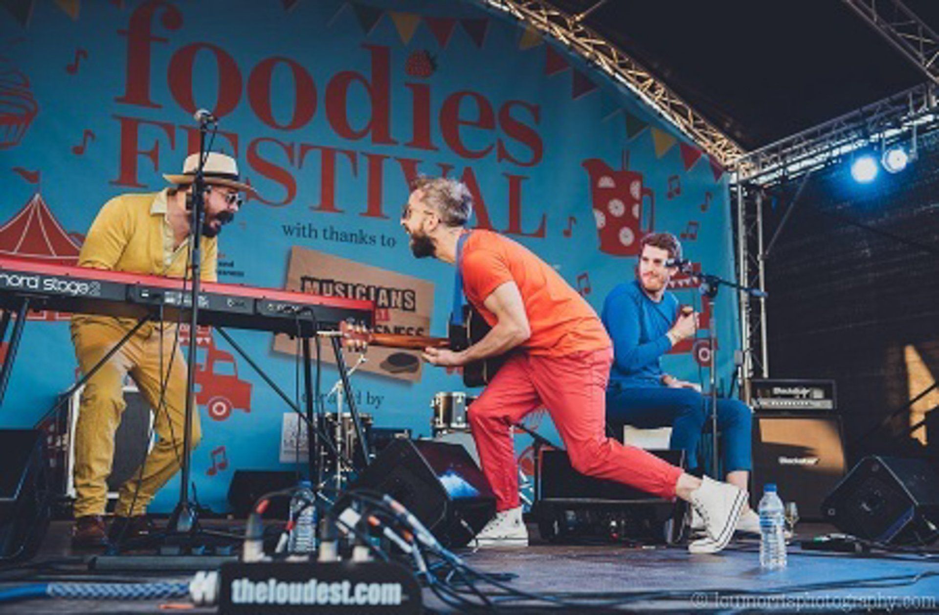 Close up of a band playing on a large arc truss stage set up for the foodies festival on a long term contract