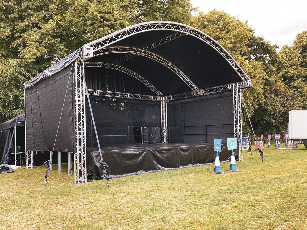 Arc roof stage set up for an outdoor event