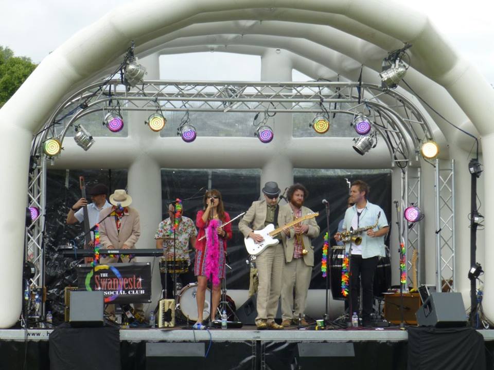 band performing on Inflatable roof stage set up for an outdoor event