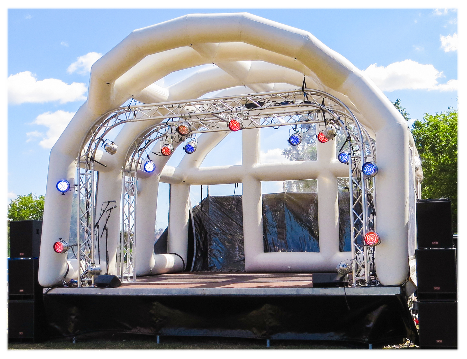 Inflatable roofed trailer stage with trusses and lights attached