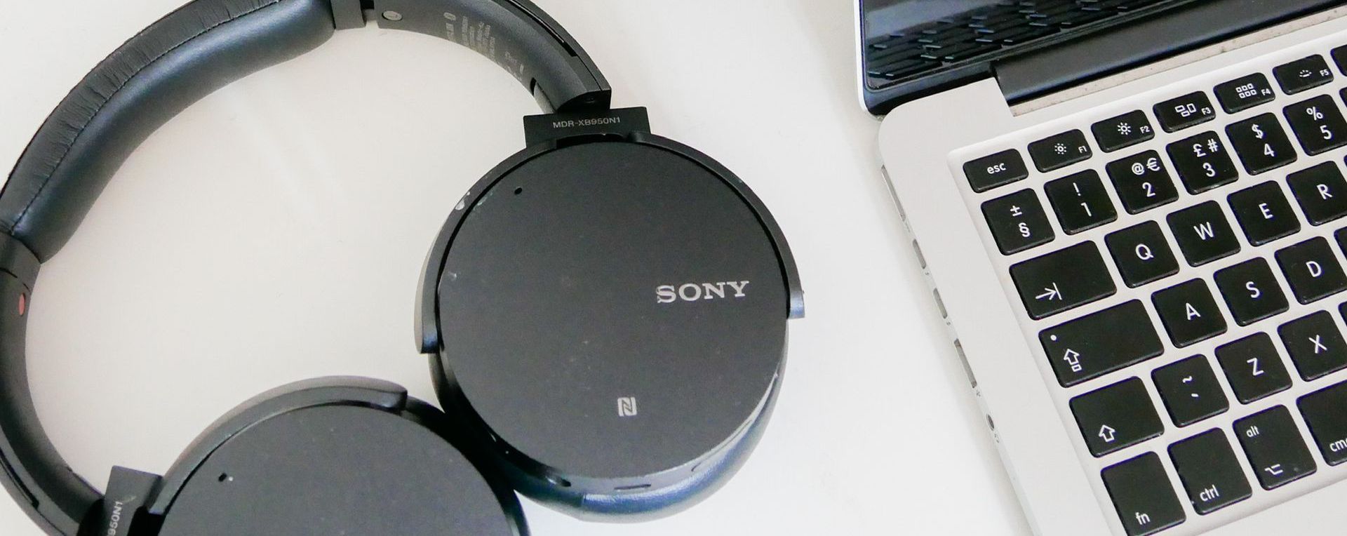 a close up of headphones and a laptop keyboard