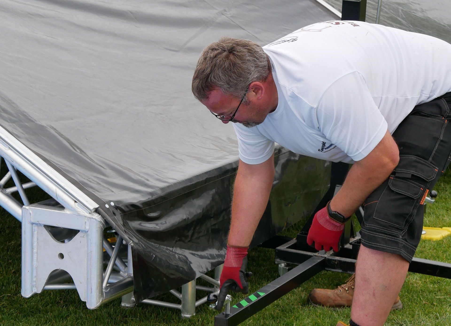 A crew member setting up a stage