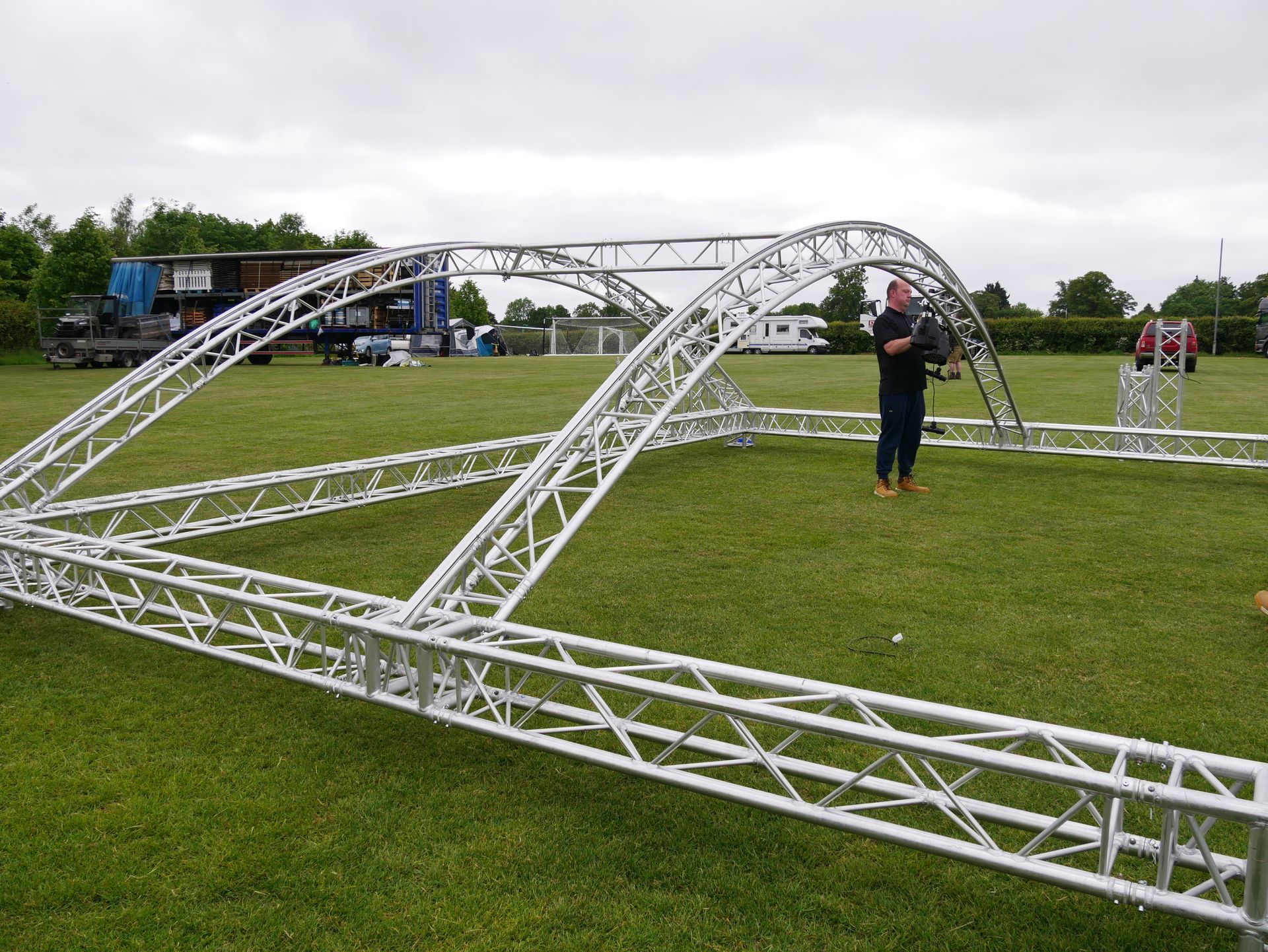 Aluminium trusses laid out on green grass