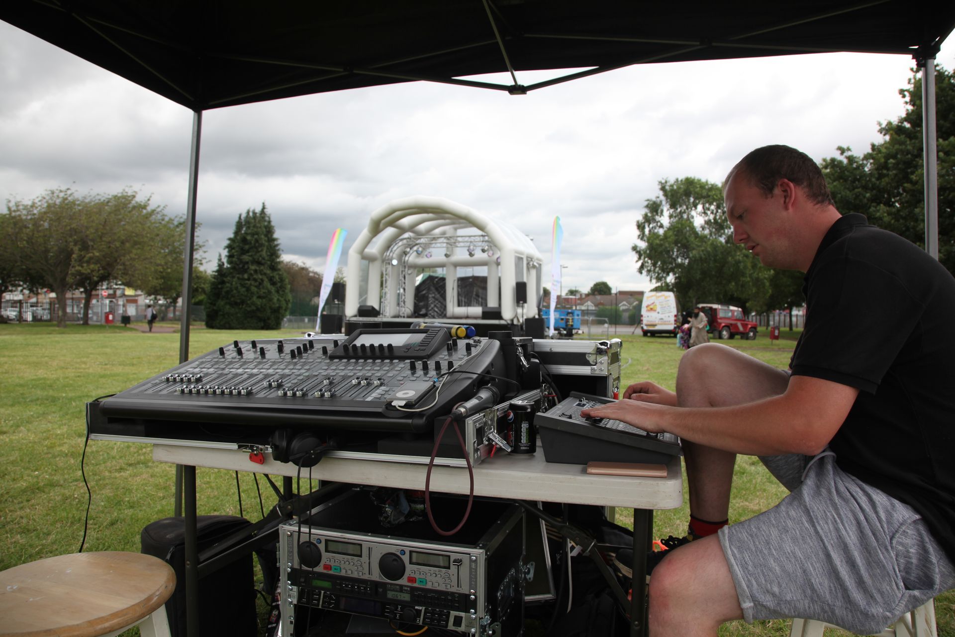 A sound desk in the front and an inflatable stage in the background at the redbridge event