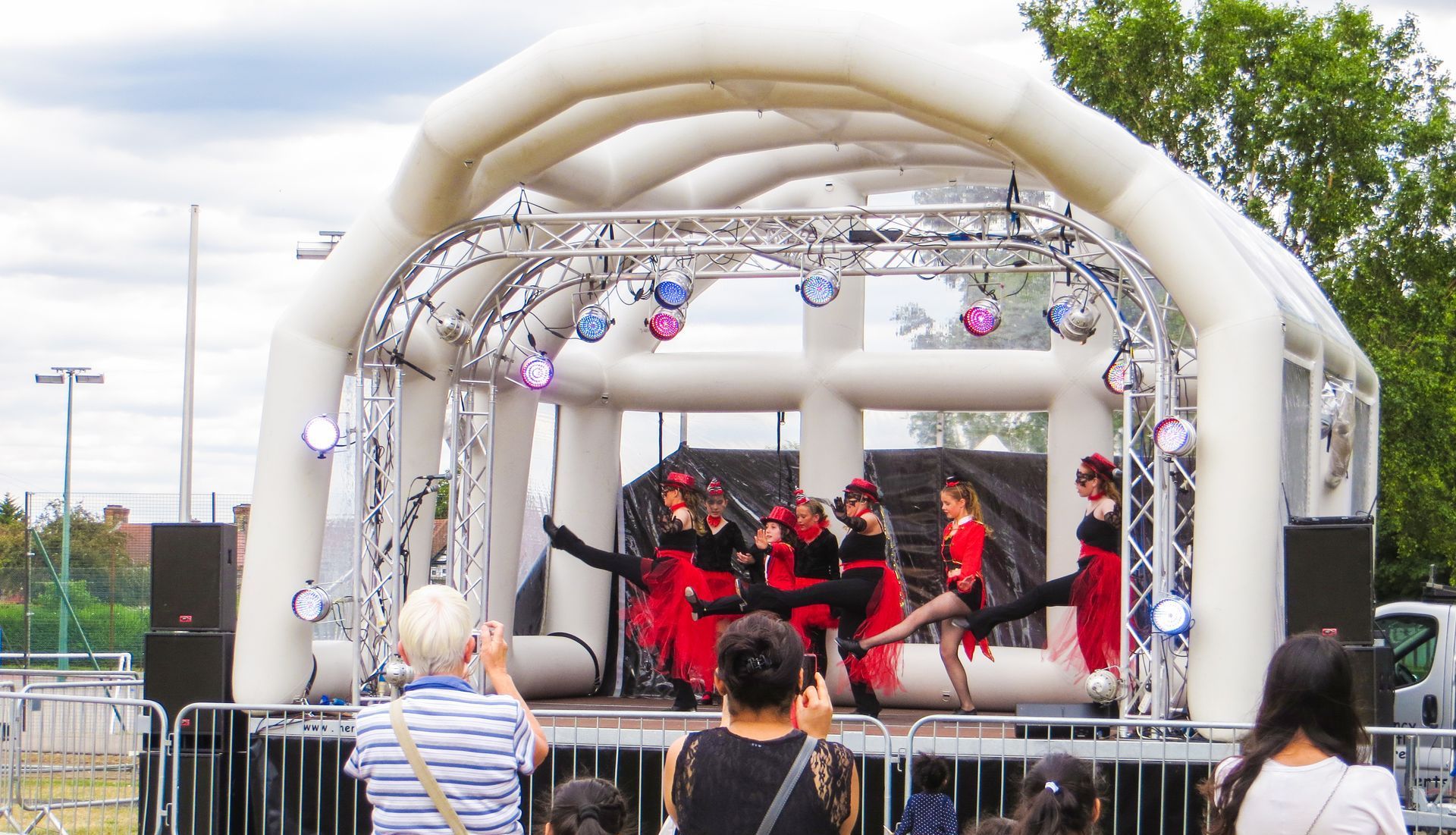 Inflatable stage at redbridge event in 2015, with dancers on stage dressed in red and black.