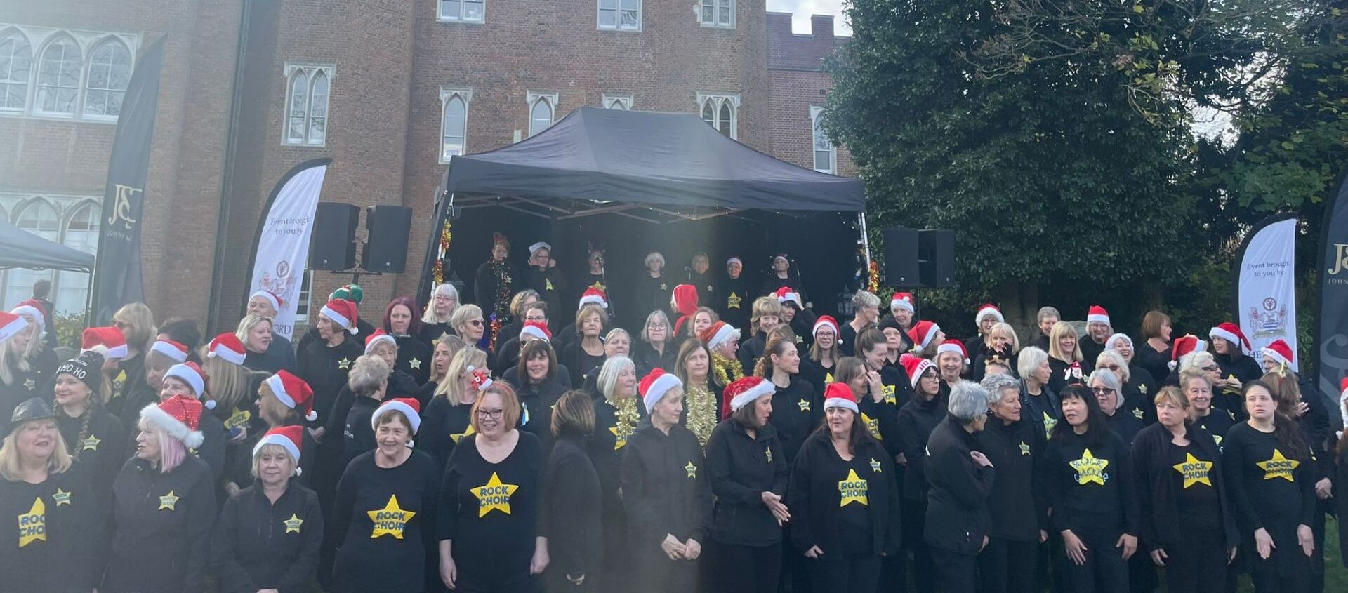 Rock Choir performing in front of Hertford Castle