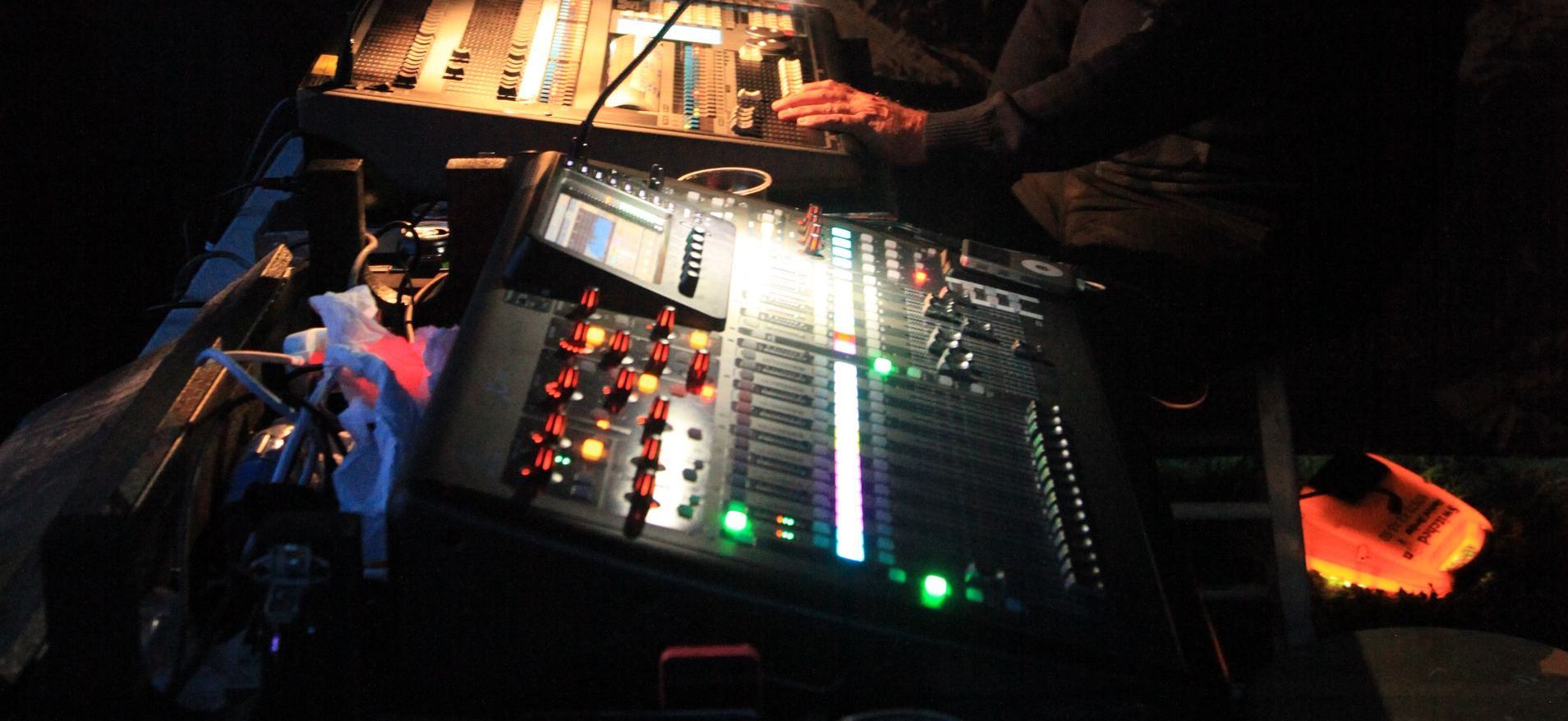 Close up of a mixing and lighting desk at night. 