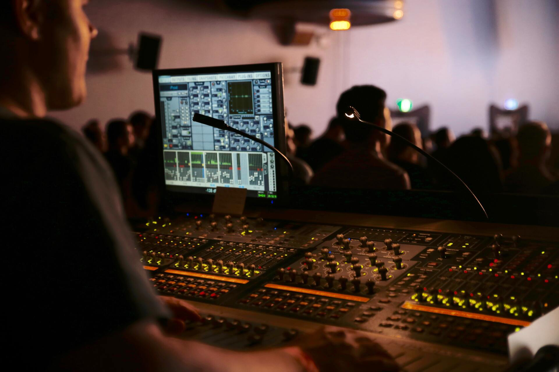 Close up of a sound engineer working at a sound desk