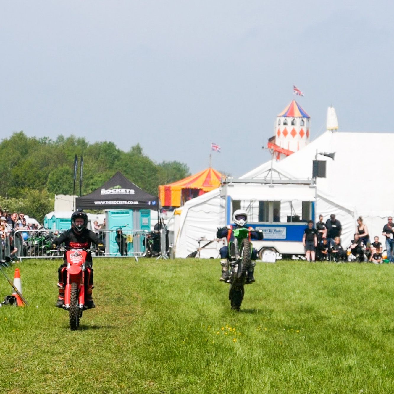 two acrobatic motorbikes in a field