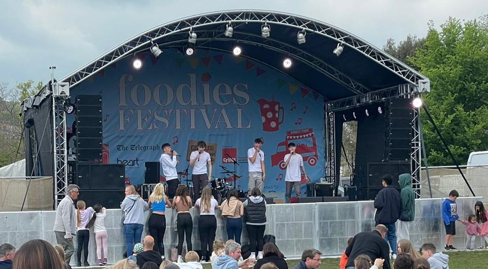 Image of a arc truss stage with a band performing