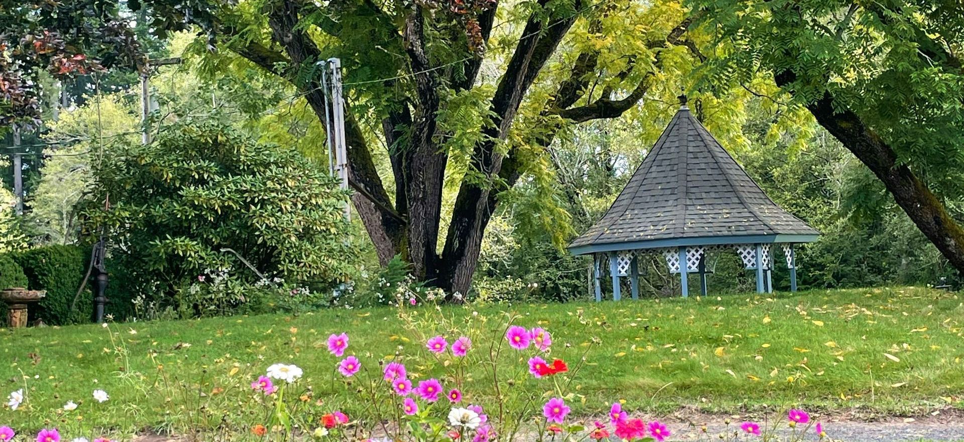 A spring garden with a gazebo in the background