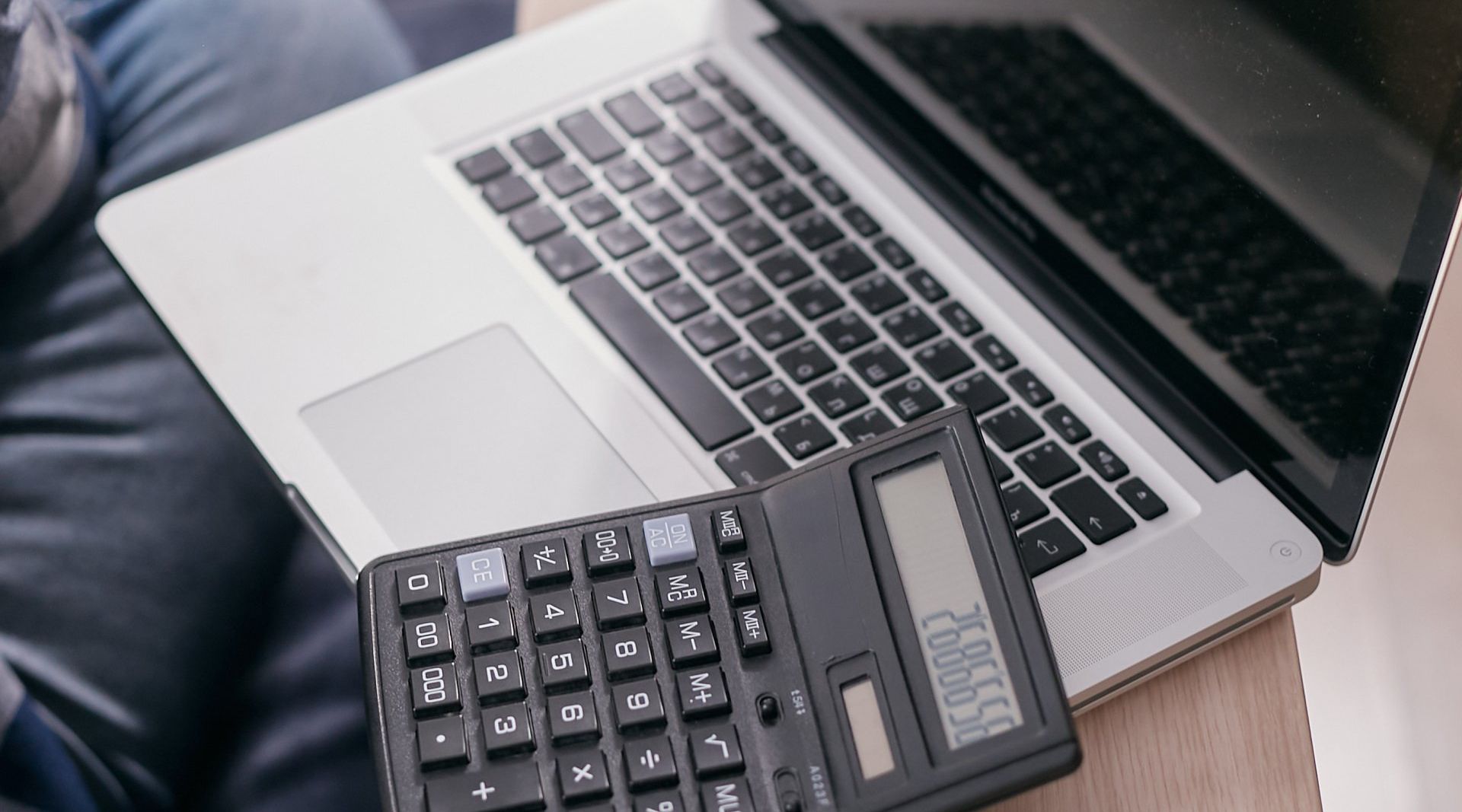 A close up of a calculator on a laptop