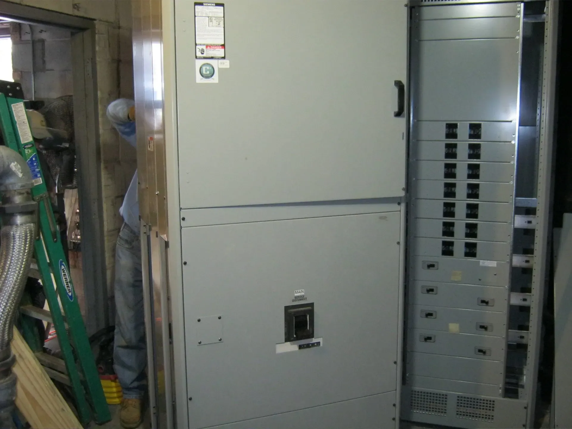 Man behind structure working on wires — Lombard, IL — Cordial Electric Inc.