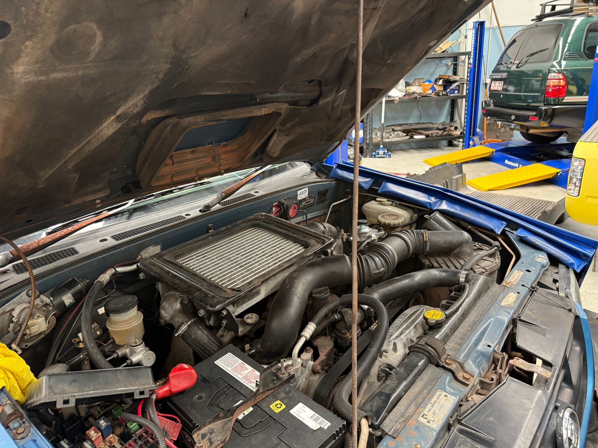 Engine Bay of a Blue Car with the Hood Open, Showing a Top-mounted Intercooler — Mad Monkeys Mechanical in Cairns City, QLD