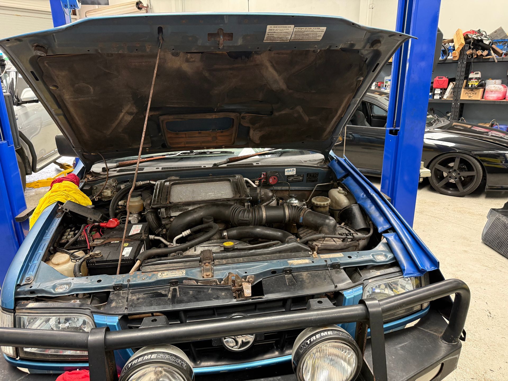 Open-hood Car with a Bull Bar and Fog Lights Inside a Professional Auto Workshop — Mad Monkeys Mechanical in Cairns City, QLD
