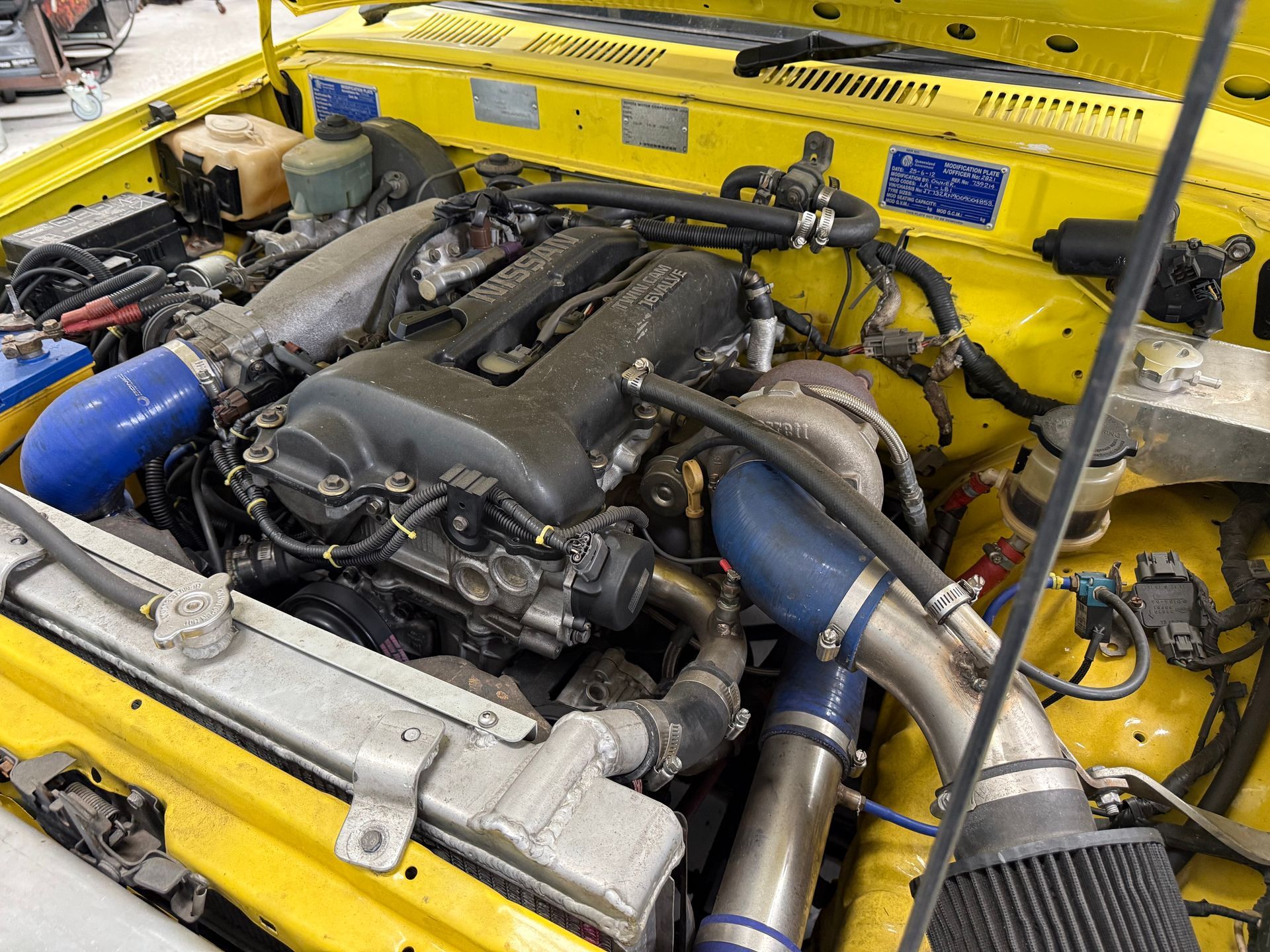 Modified Engine Bay Inside a Yellow Car Body, Featuring a Turbocharged Engine — Mad Monkeys Mechanical in Cairns City, QLD