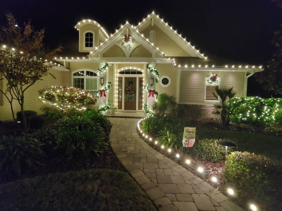 a house is decorated with christmas lights at night