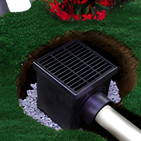 a french drain is sitting in the middle of a hole in the ground .