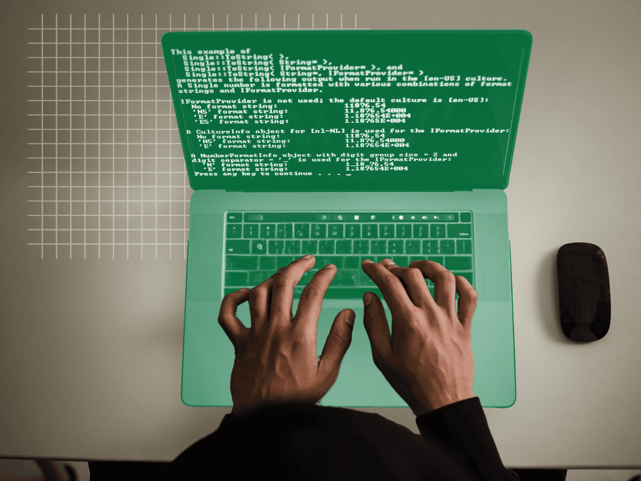 A person is typing on a green laptop computer