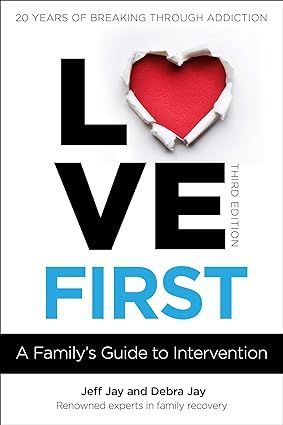 Cover of "Love First," a guide to addiction intervention, with a heart shape in the center.