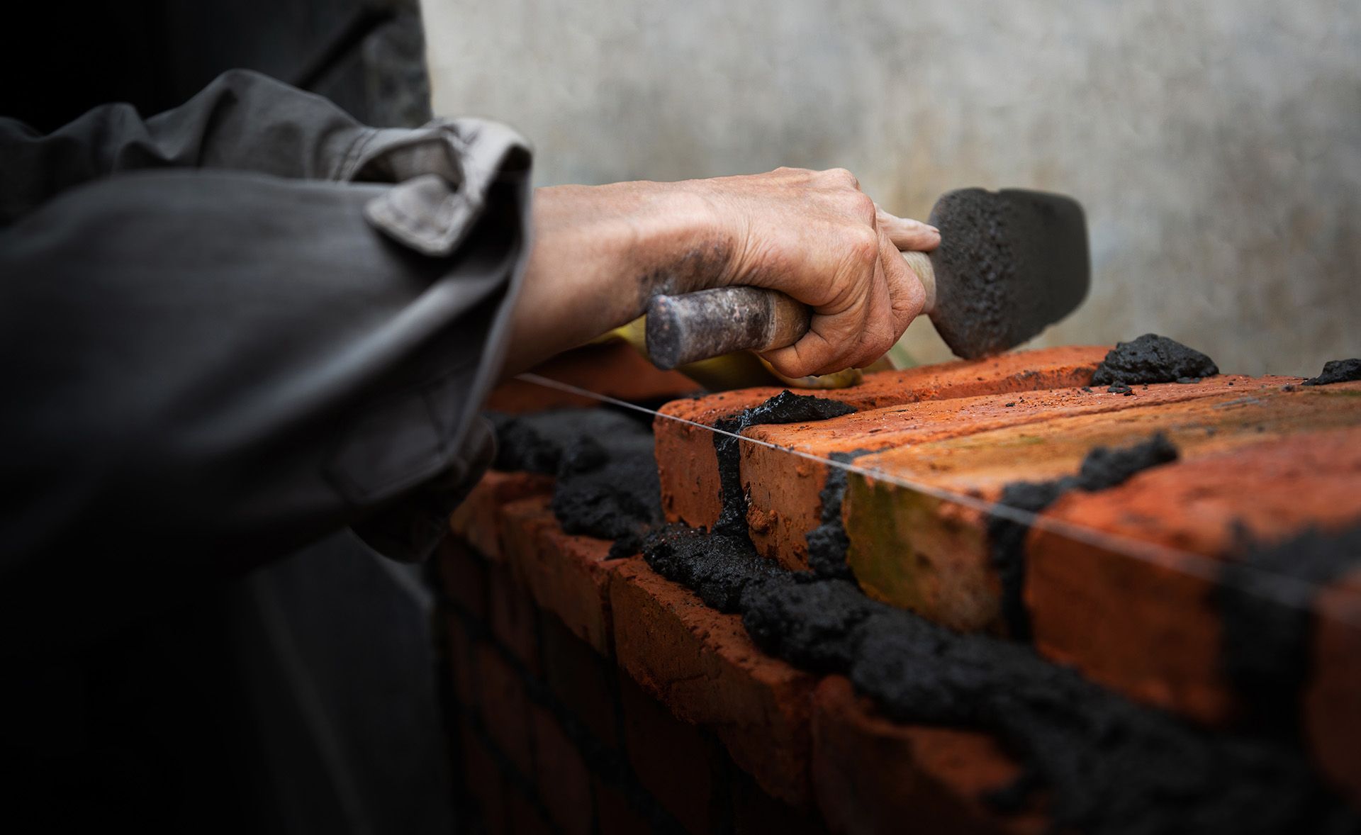 Brick wall construction with fresh mortar application.