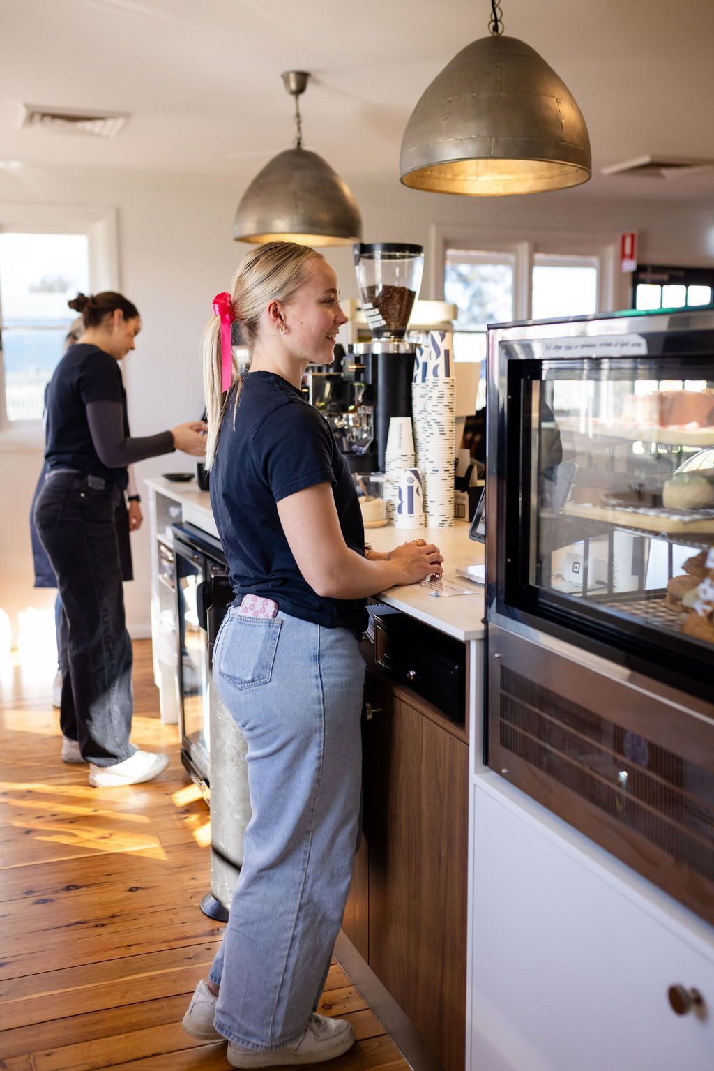 Woman taking orders at counter