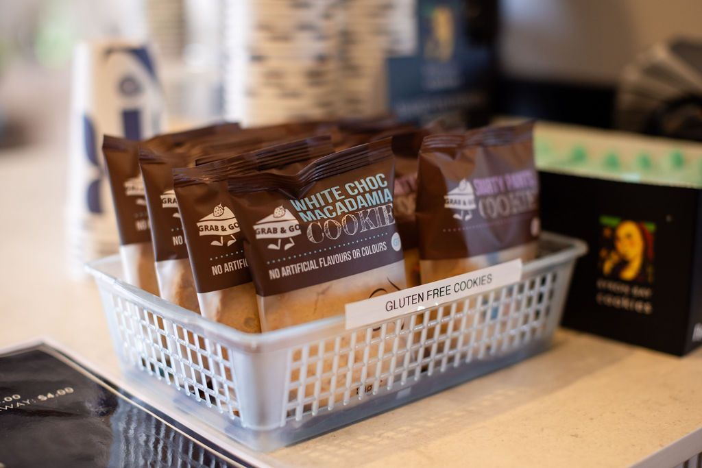 A basket of cookie packets is sitting on a table.