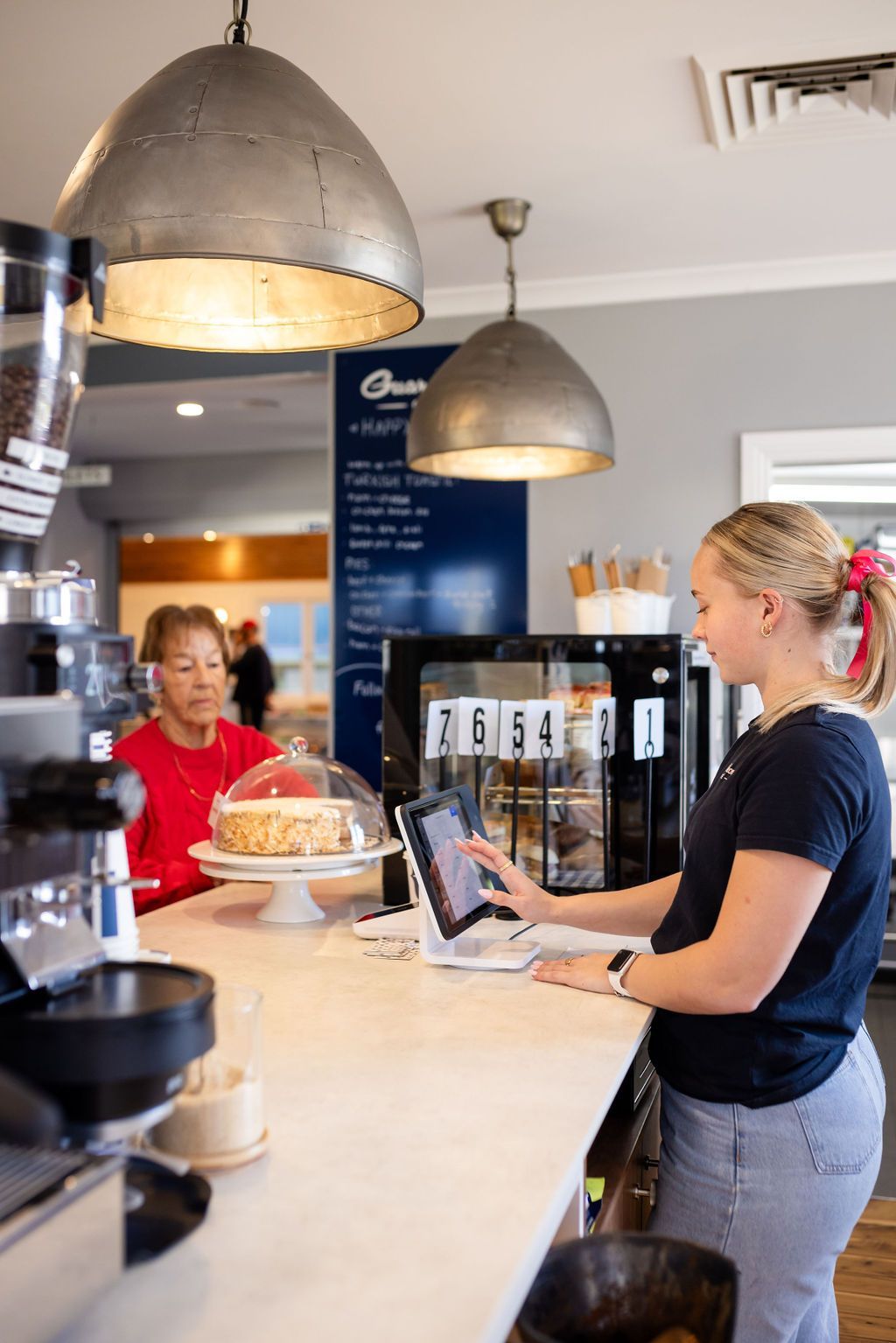 Woman taking orders at counter