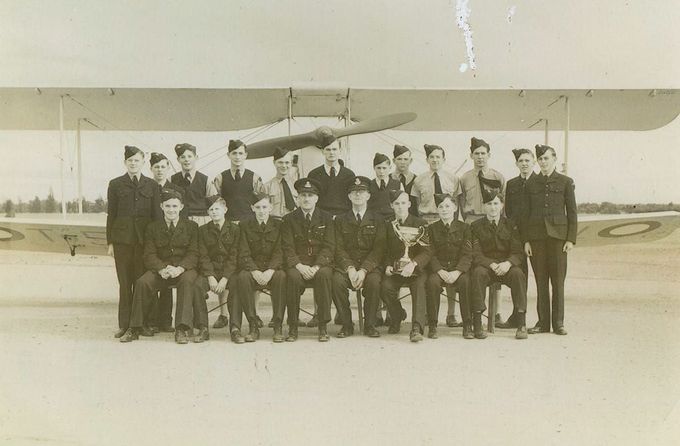 Group of men in front of plane