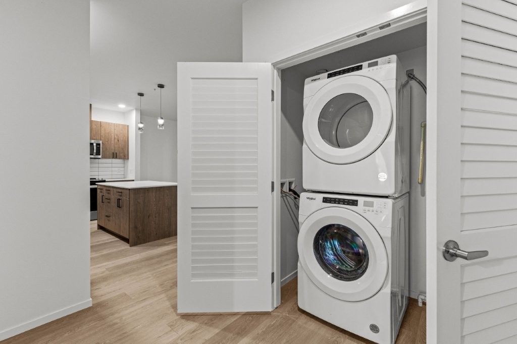 A washer and dryer are stacked on top of each other in a closet.