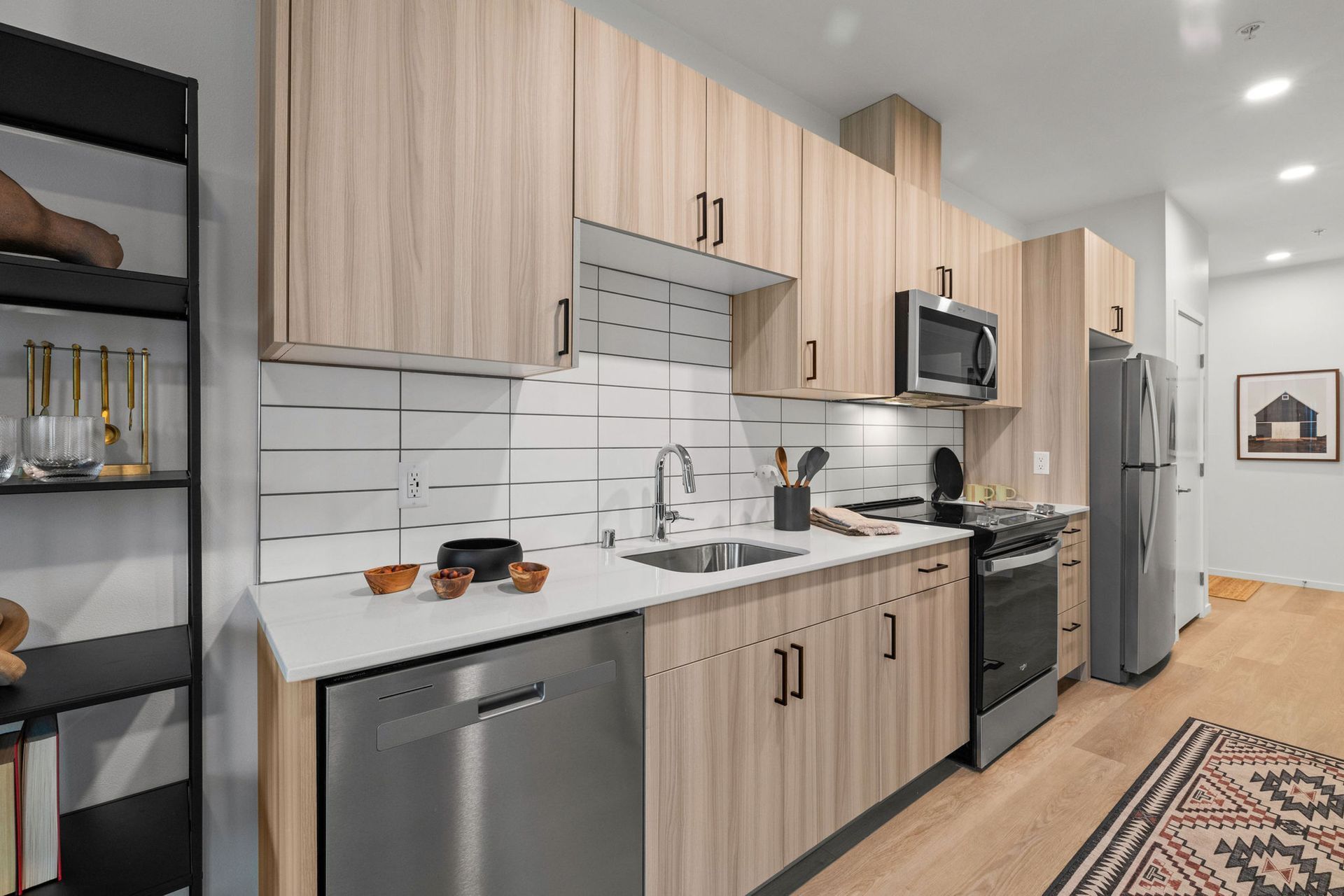 A kitchen with wooden cabinets and stainless steel appliances.