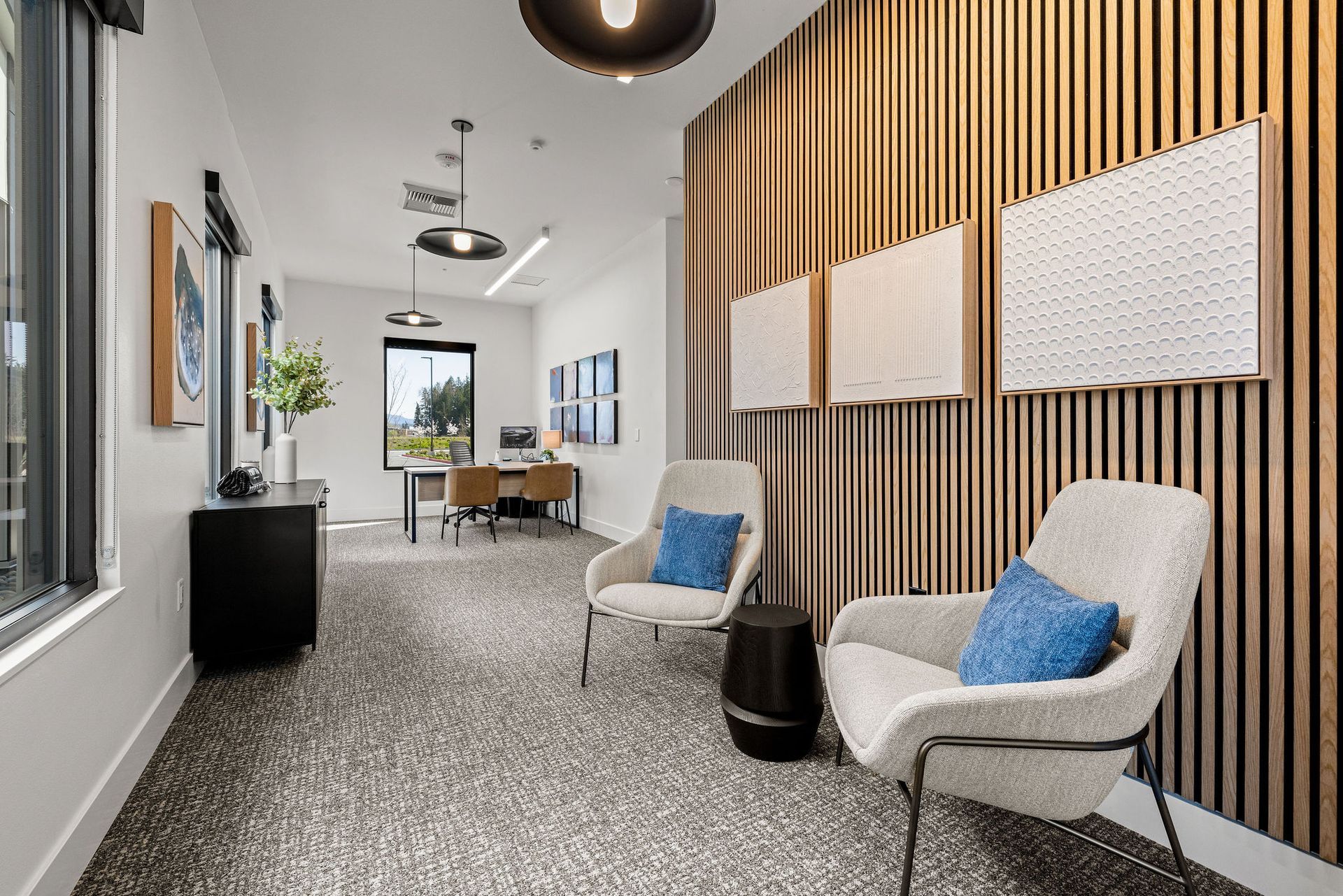 A hallway with two chairs and a wooden wall.