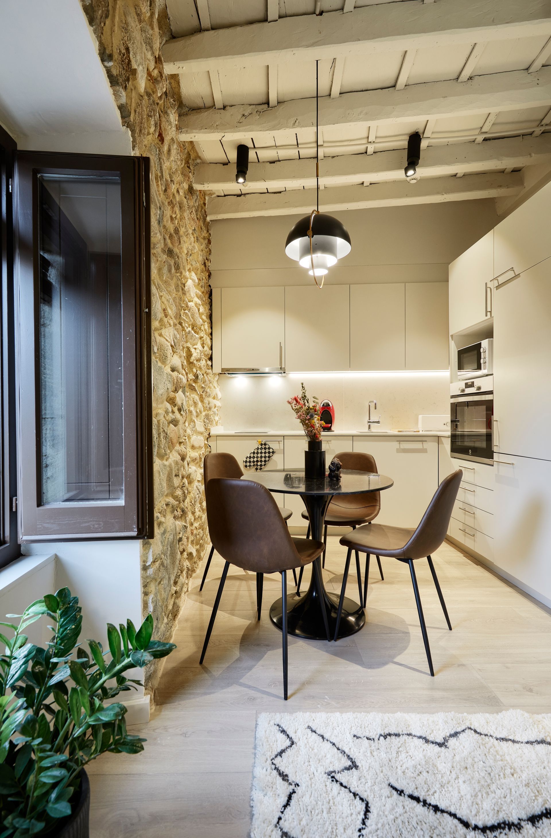 A kitchen with a table and chairs in it