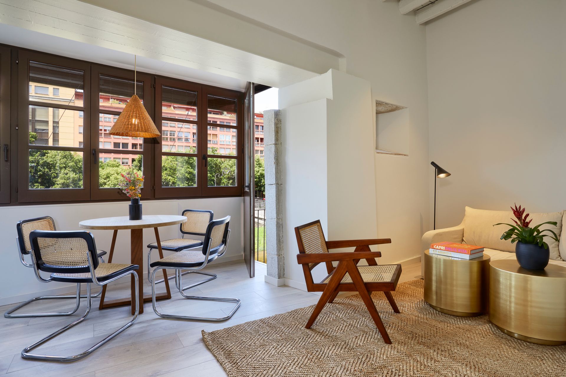 A living room with a table and chairs and a couch.