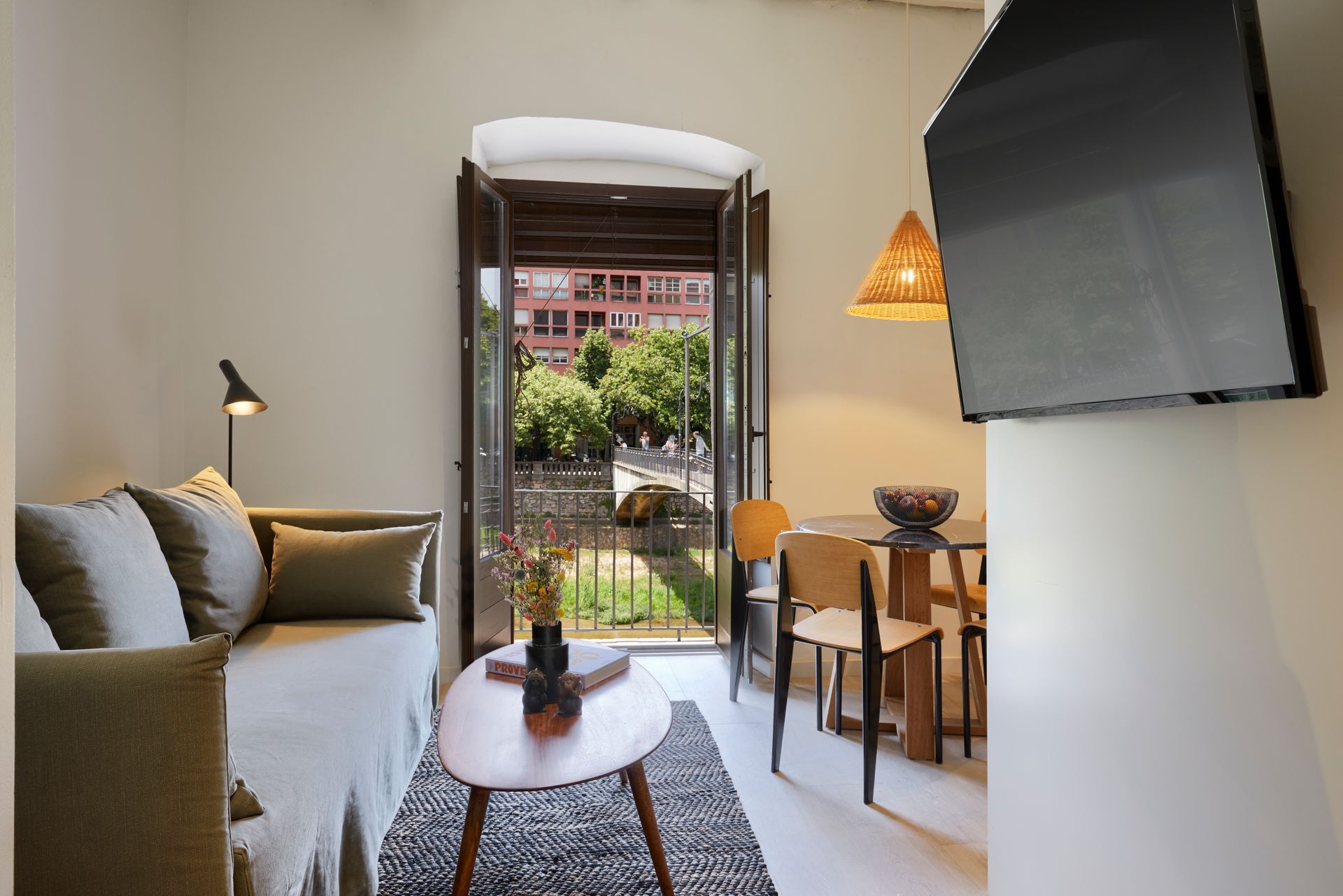 A living room with a couch , table and television.
