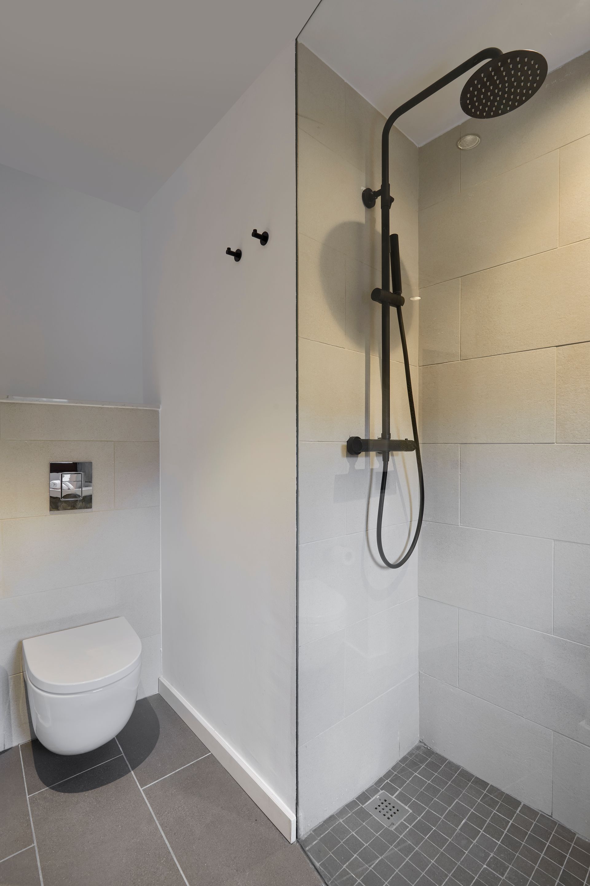 There is a toilet and a shower in the bathroom.