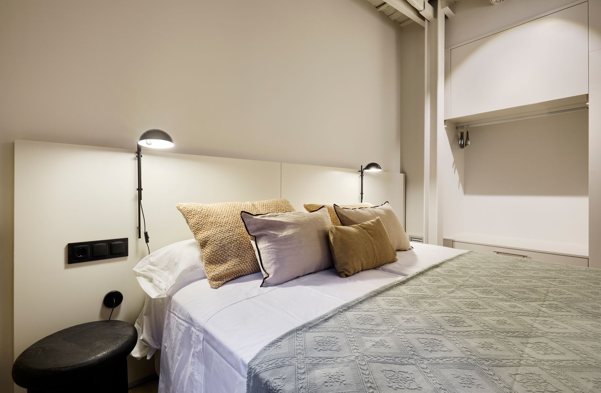 A bedroom with a bed and pillows on it.