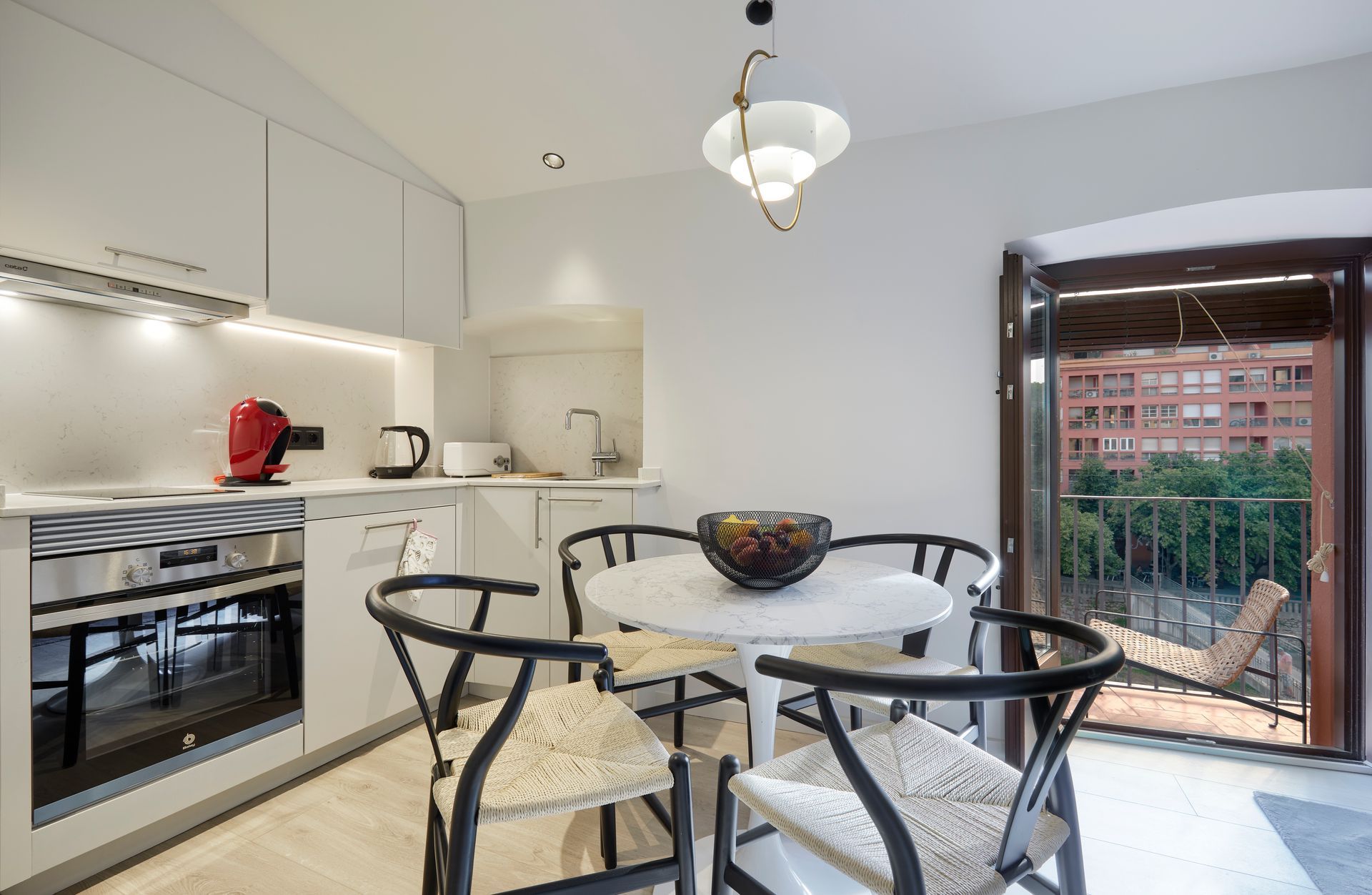 A kitchen with a table and chairs in it