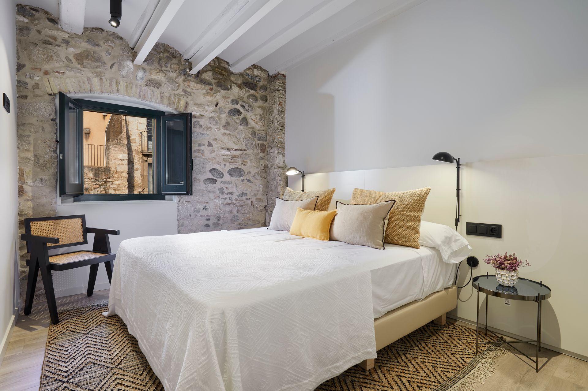 A bedroom with a large bed and a window