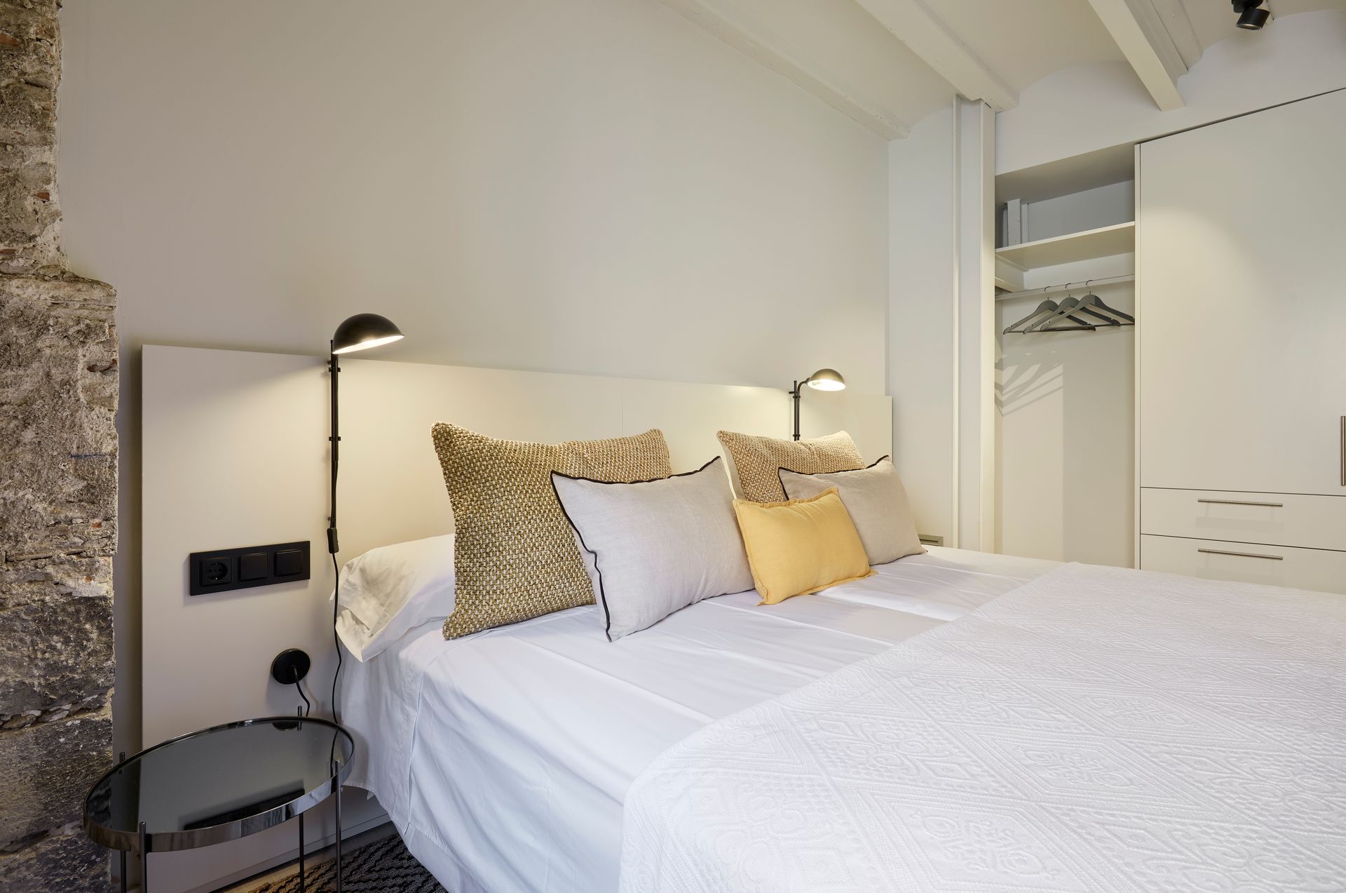 A bedroom with a large bed and a closet