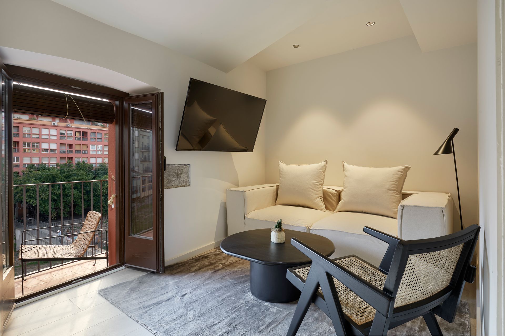 A living room with a couch , chair , table and television.